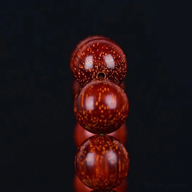Tibetan red sandalwood mala bracelet on neutral background, meditation and spiritual practice tool