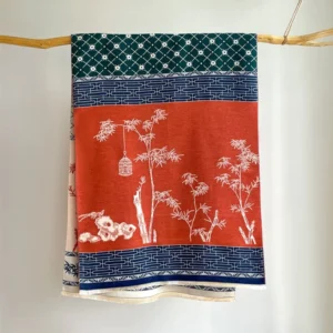 Handwoven Tibetan meditation scarf with bamboo leaf and birdcage motifs in earthy tones, flat lay showcase