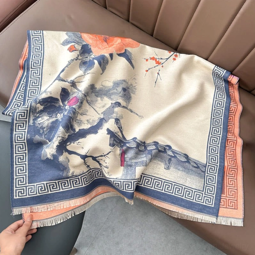 Blue and orange Tibetan scarf on sofa flat lay, light steel blue base with blue-brown Greek key border and artistic floral print