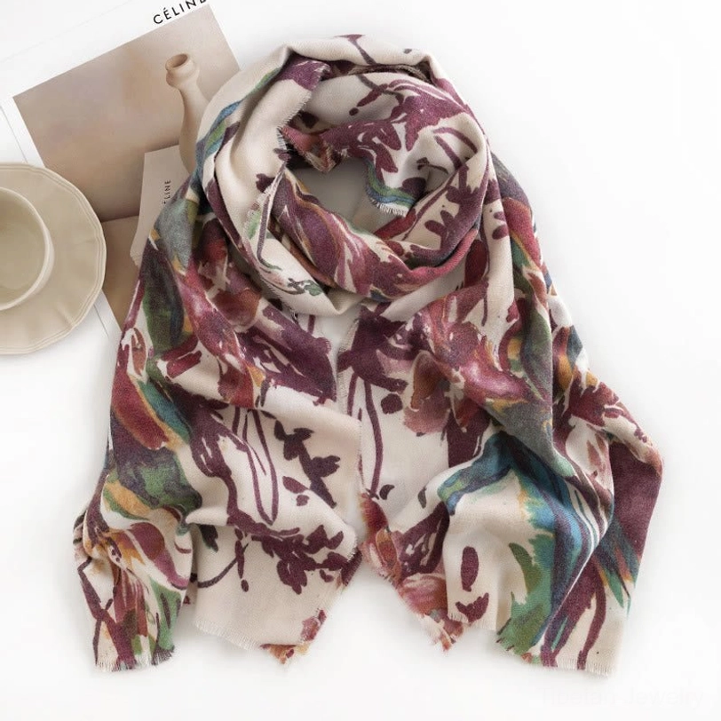 Coiled Tibetan shawl display showing muted earthy watercolor floral pattern and soft woven texture
