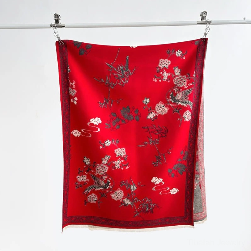 Rich red Tibetan floral bird scarf hanging with border trim and bird-flower print against white background