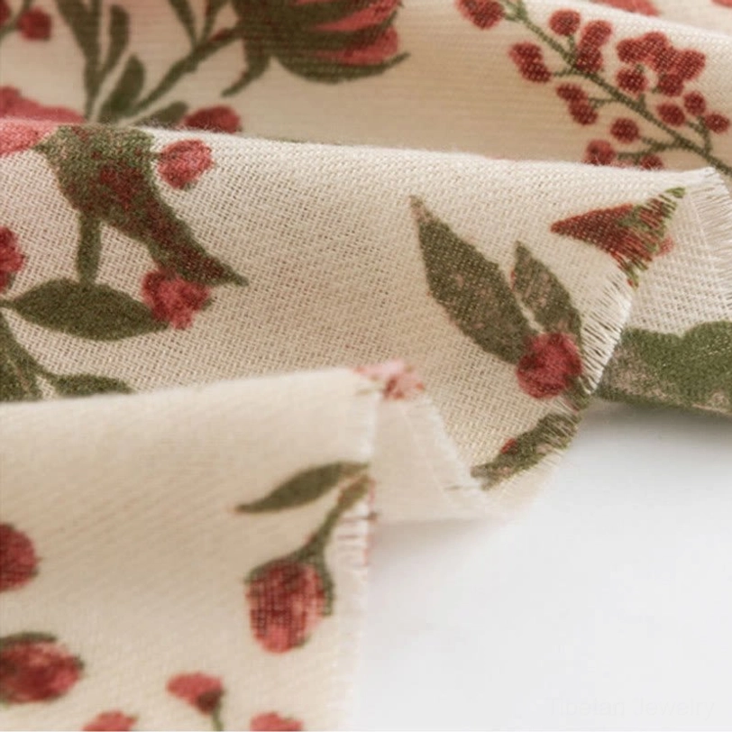 Tibetan scarf edge detail macro showing raw hem and fine berry and leaf print craftsmanship