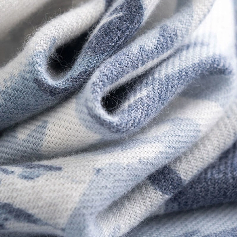 Close-up detail of Tibetan scarf fabric texture showing fluffy thick woven material with gradient blue and white color blocks
