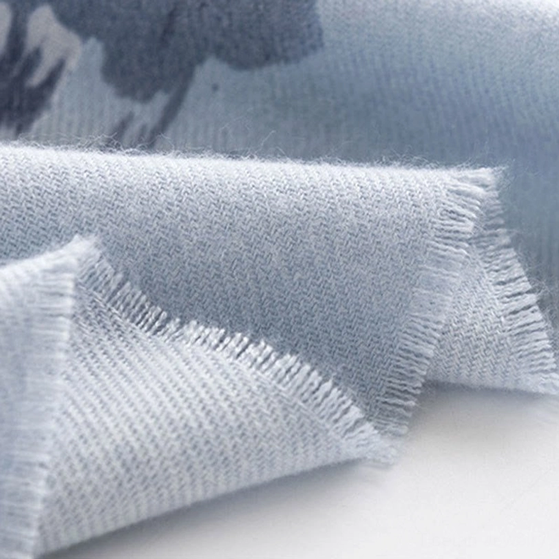 Tibetan scarf fabric close-up shot emphasizing thick cozy woven textile with frayed raw edge and neutral light blue color