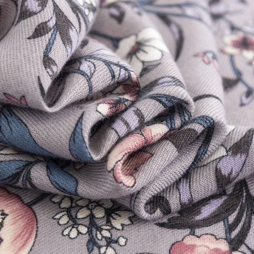 Close-up detail of Tibetan scarf fabric texture, soft woven weave with clear camellia flower print definition