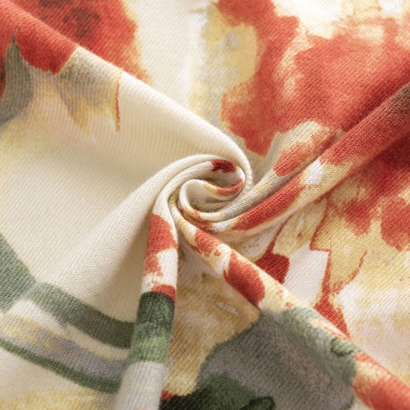 Twisted view of Tibetan floral scarf close-up showing cream base with rust and yellow watercolor flower print