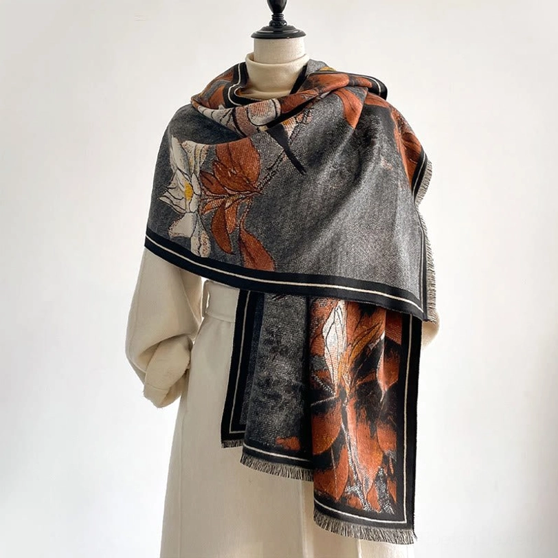 Grey and rust Tibetan magnolia bird scarf worn on mannequin - front styling view with black border
