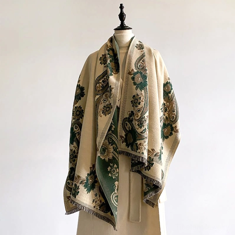 Tibetan handwoven reversible scarf with traditional paisley and floral motifs, three-quarter mannequin view showcasing authentic cultural heritage styling