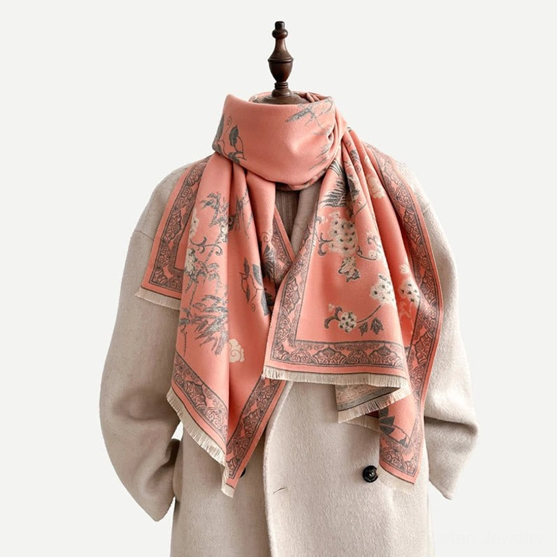 Model wearing light pink Tibetan bird and bamboo leaf scarf around neck, front view studio