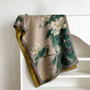 Flat lay of reversible Tibetan scarf showing dual-sided design with magnolia flower and bird print pattern