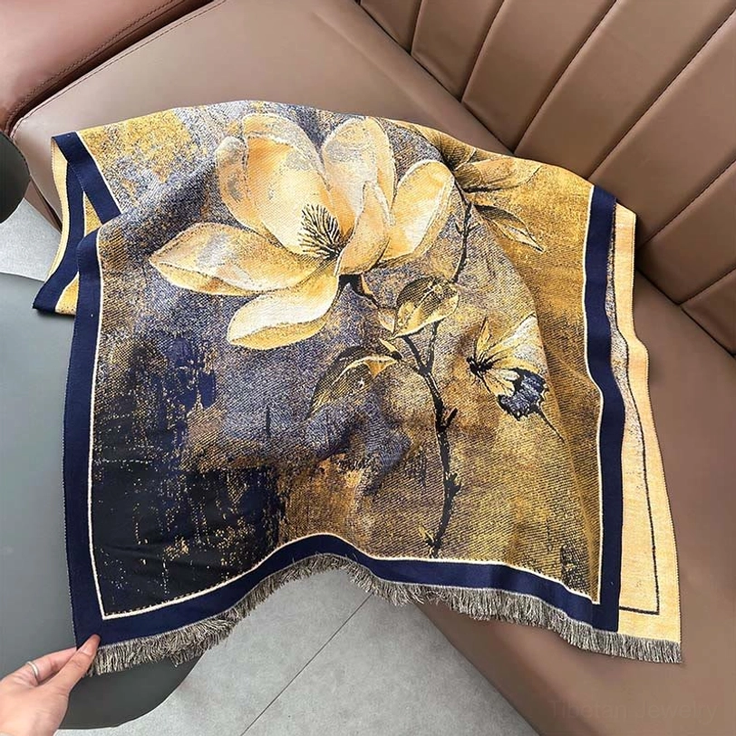 Artisan Tibetan scarf on leather sofa, yellow purple navy vintage floral print with fringed hem