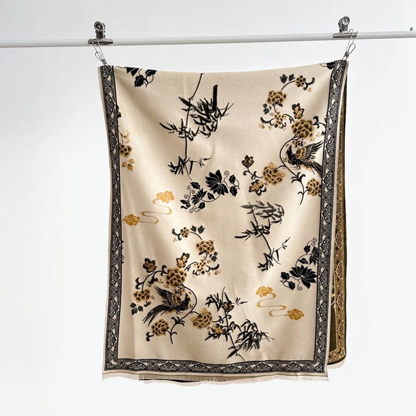 Tibetan scarf flat lay detail view showing bamboo leaf and bird jacquard weave pattern