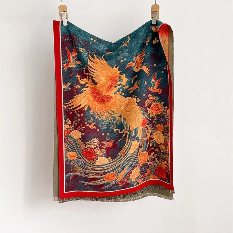 Tibetan phoenix scarf flat lay display showing teal and maroon base with golden phoenix print and red edge trim
