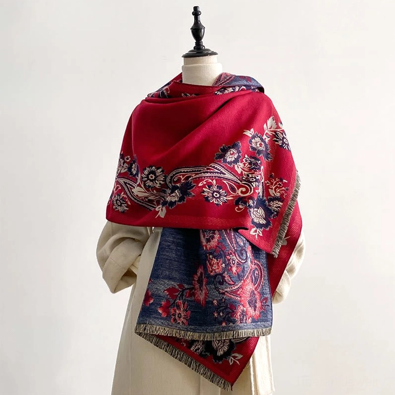 Tibetan reversible paisley scarf with red base and blue floral motifs, three-quarter view on dress form showcasing dual-sided patterned design