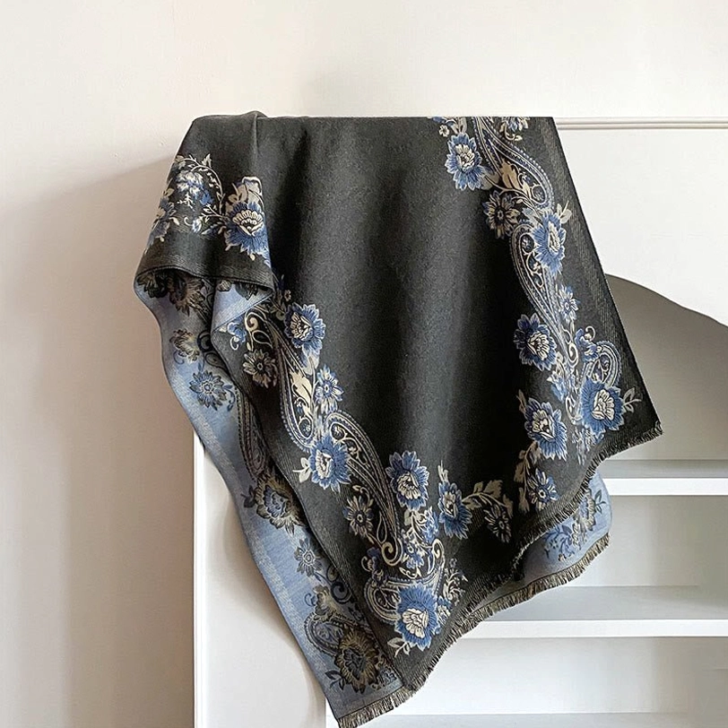 Slate gray Tibetan reversible scarf with paisley floral trim, flat lay shelf display showing soft woven construction and fringed edges
