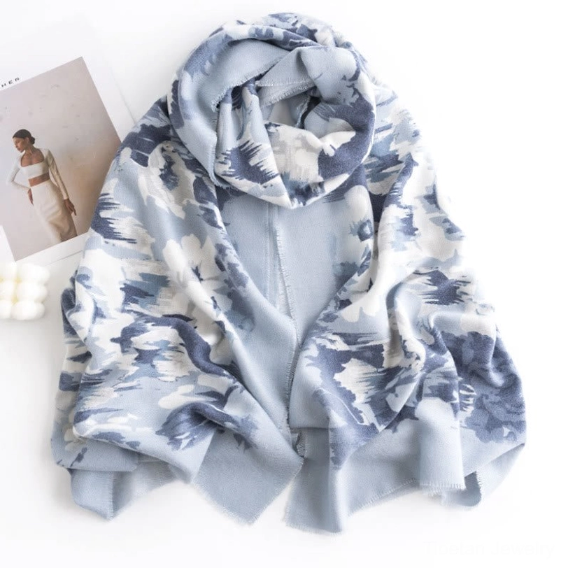 Woman wearing Tibetan floral scarf wrap around neck in front view, studio setting showcasing blue-white print draped styling