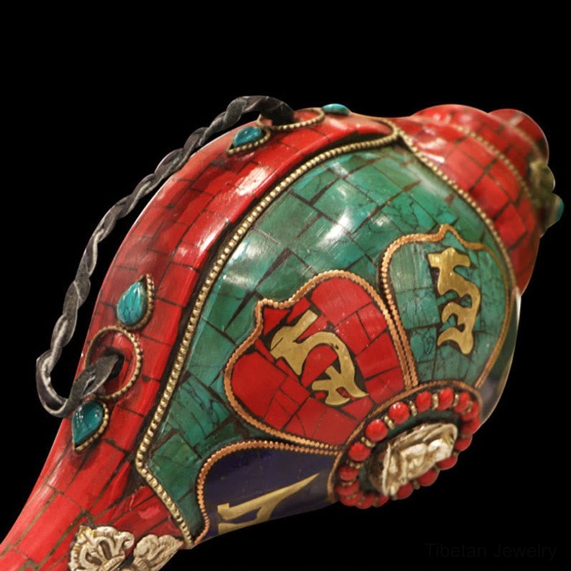 Close-up front view of intricate Tibetan shankha mosaic work with gold mantra carvings and metal inlays