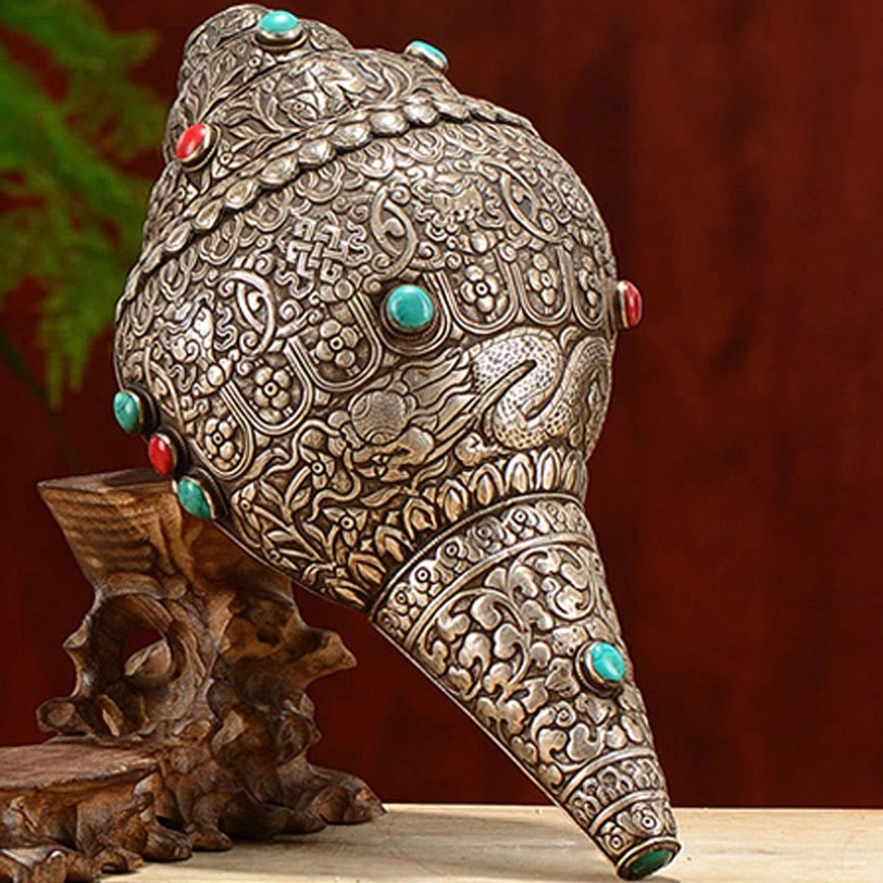 Collectible Tibetan shankha conch shell art piece with hand-carved auspicious symbols and gemstone embellishments