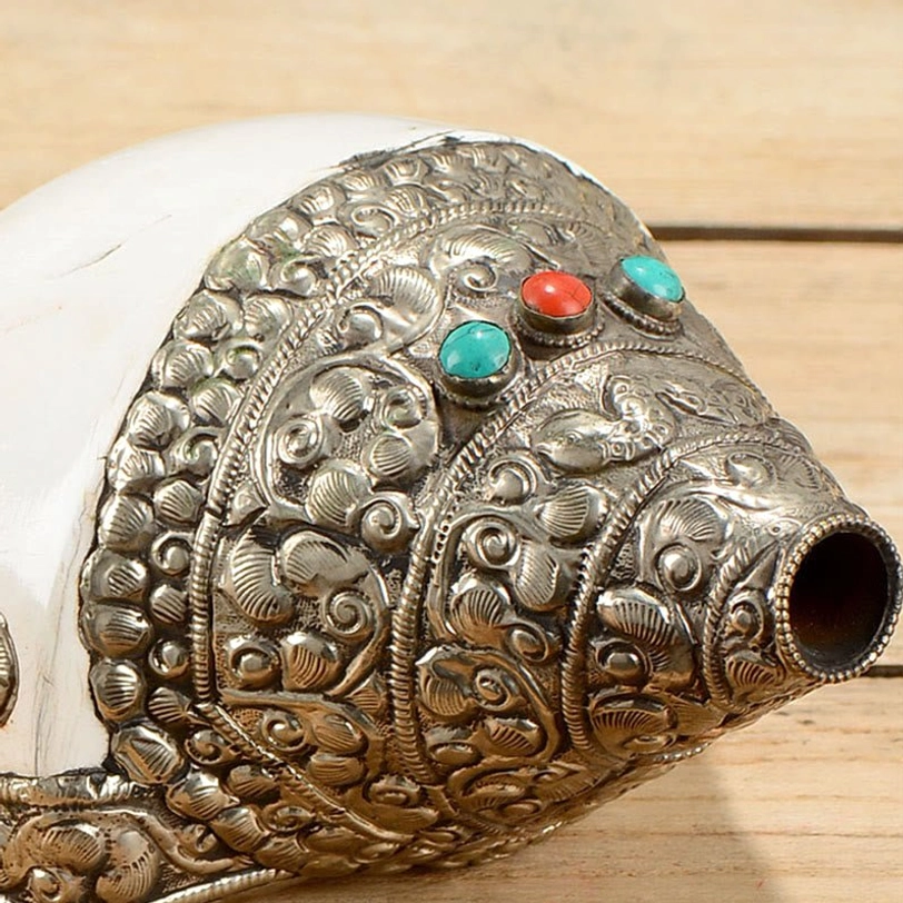 Authentic Tibetan shankha conch shell decorated with traditional carved patterns and semi-precious stone settings