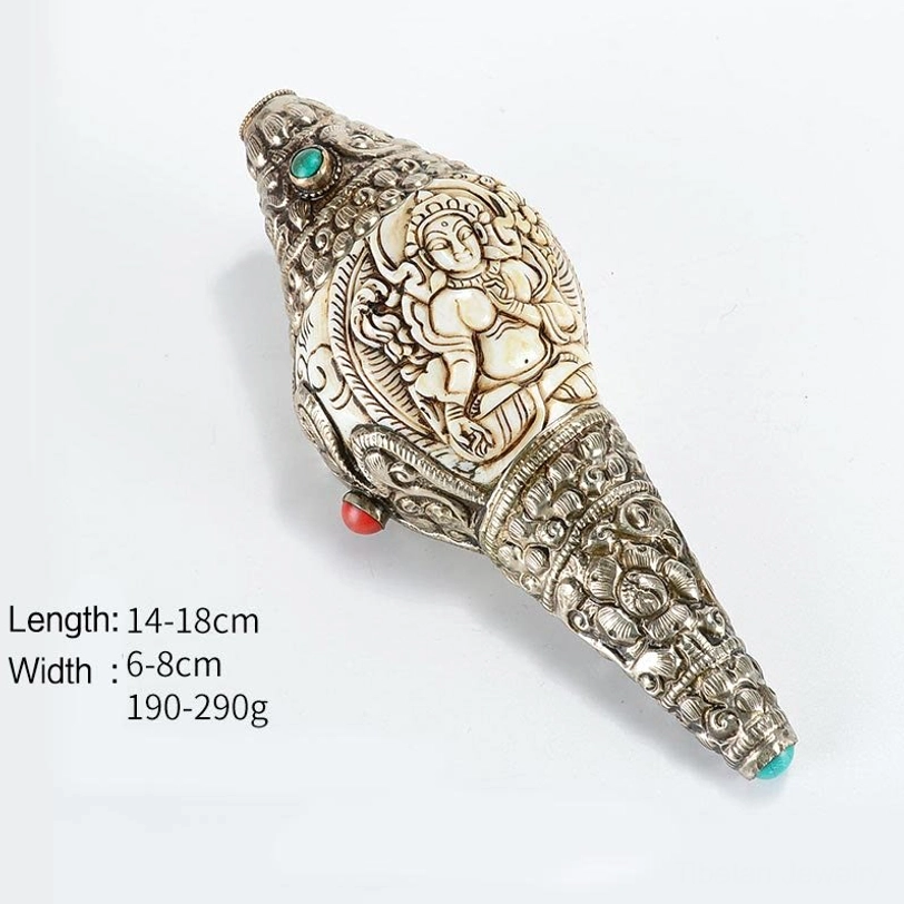 Tibetan Shankha wealth decoration with Buddha relief carving, silver wrapped edges and gemstone inlays on white background