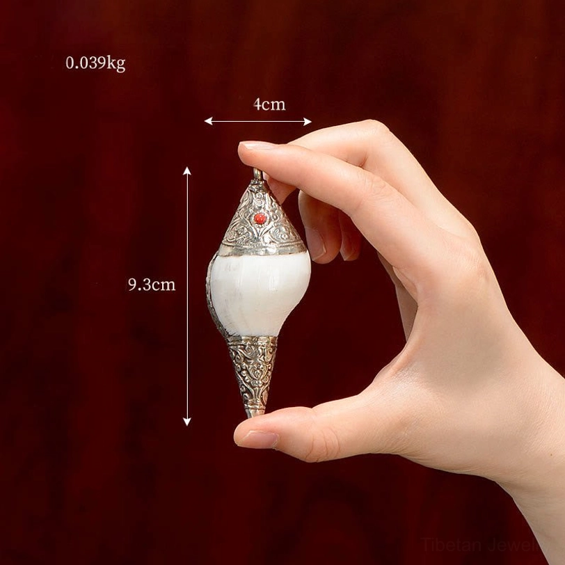 Extra small Tibetan shankha conch shell 9.3cm size held by hand showing natural white conch with silver base