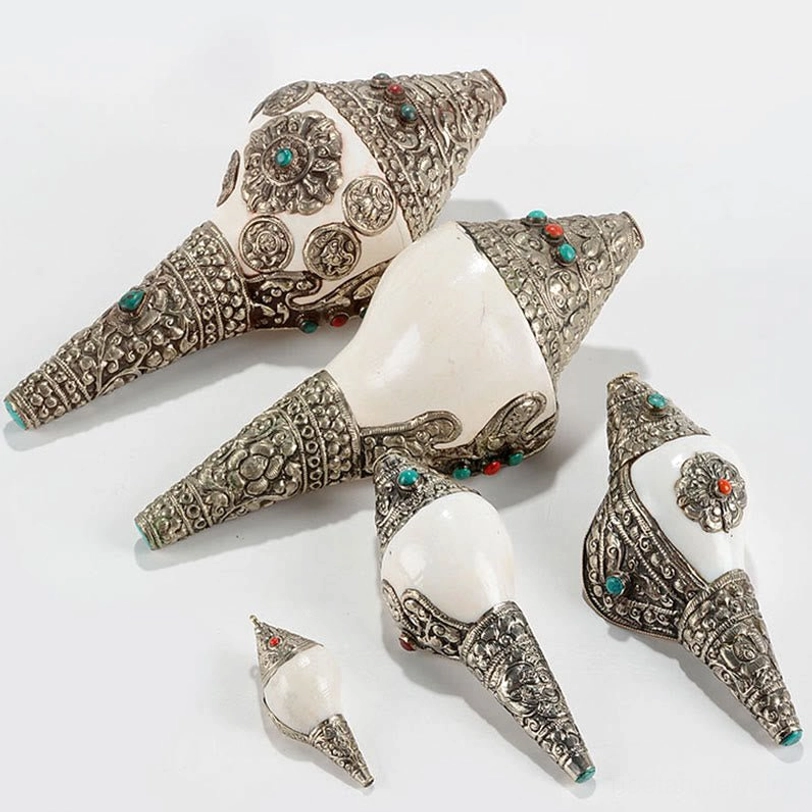 Handcrafted Tibetan shankha conch shell showing natural marine texture with artisanal silver mount and bead work