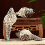 Tibetan hand-engraved Shankha conch shell decorations with silver filigree and turquoise inlays on wooden display stand