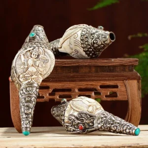 Tibetan hand-engraved Shankha conch shell decorations with silver filigree and turquoise inlays on wooden display stand