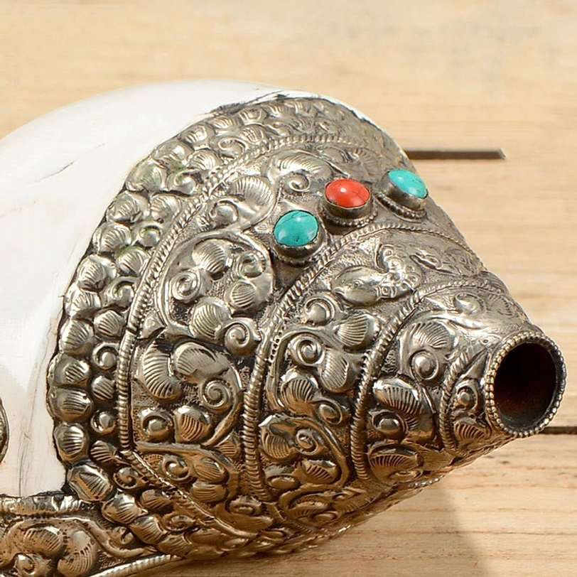 Overhead detail of Tibetan shankha conch shell blowhole with turquoise and coral inlay on silver ornament