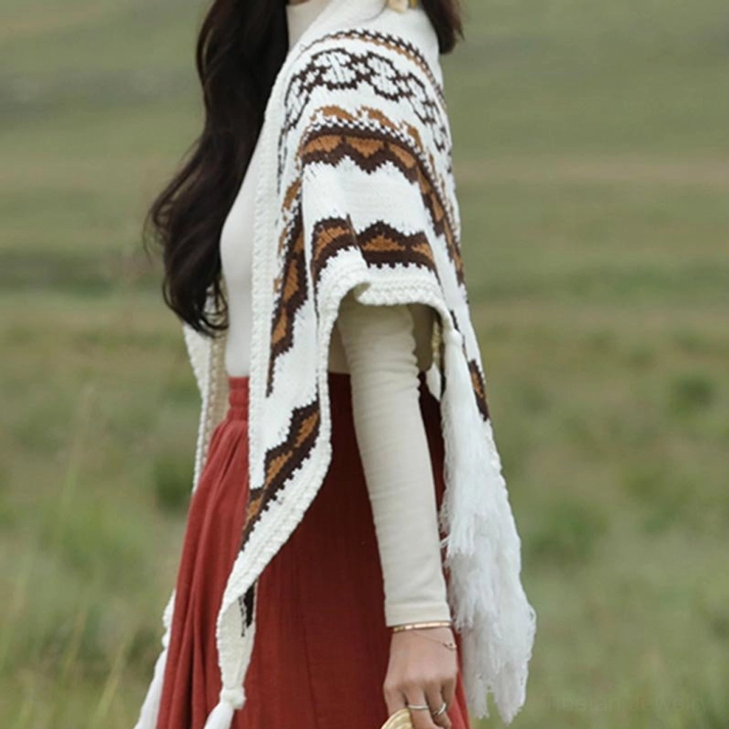 Close-up back view of Tibetan ethnic shawl displaying geometric ethnic prints and long side tassels