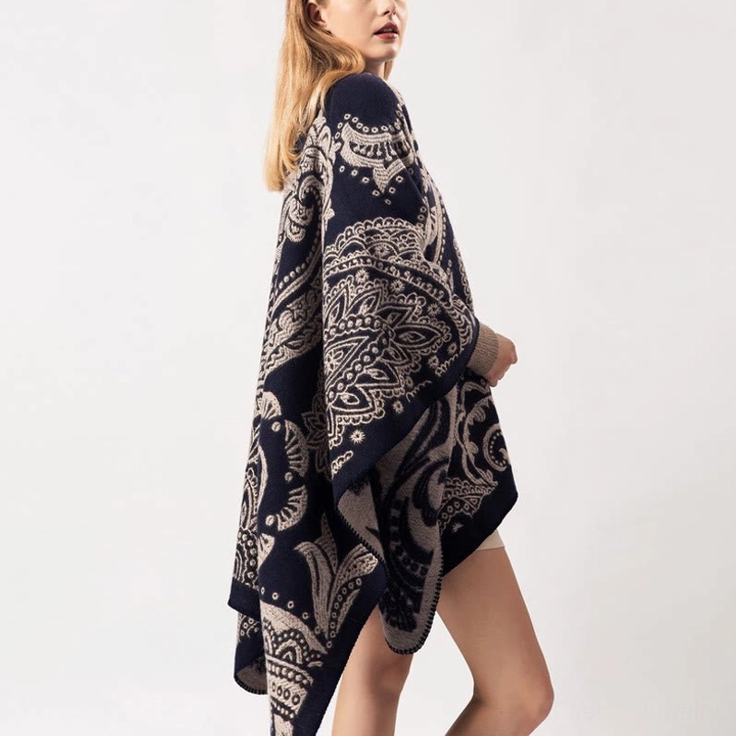 Tibetan shawl poncho wrap, side back view on model wearing navy and taupe paisley pattern, showing irregular hemline