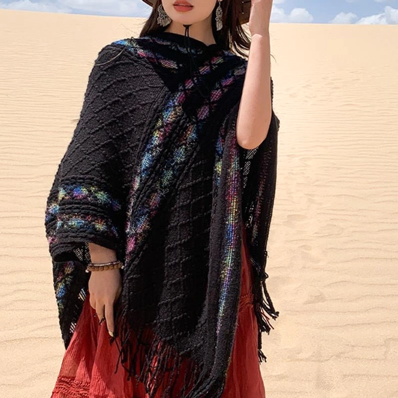 Black ethnic tassel poncho shawl front three-quarter view with rhombus knit and colorful embroidered border
