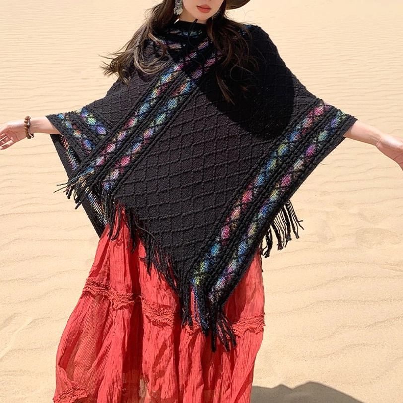 Black knitted tassel shawl wide open front view showing rhombus knit pattern and colorful ethnic border in desert