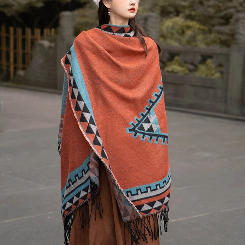 Detailed close-up of Tibetan geometric tassel shawl showing rhombus patterns, tribal motifs, and hand-tied fringe craftsmanship