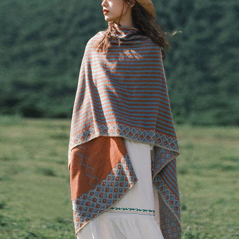 Tibetan diamond striped shawl gray-blue and rust brown worn outdoors on grassland, showing geometric pattern and ethnic design details