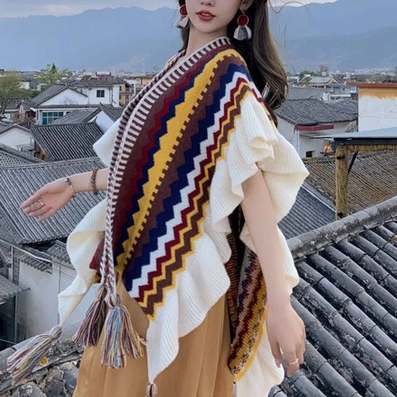 Tibetan knit shawl wrap styled as evening accessory showcasing bohemian striped pattern and elegant tassel trim
