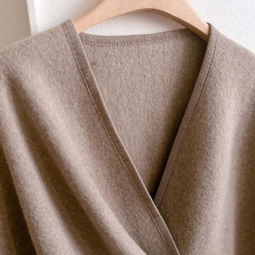Close-up detail of Tibetan shawl fabric - light tan color, fine fuzzy texture, V-neck seam trim, handcrafted quality