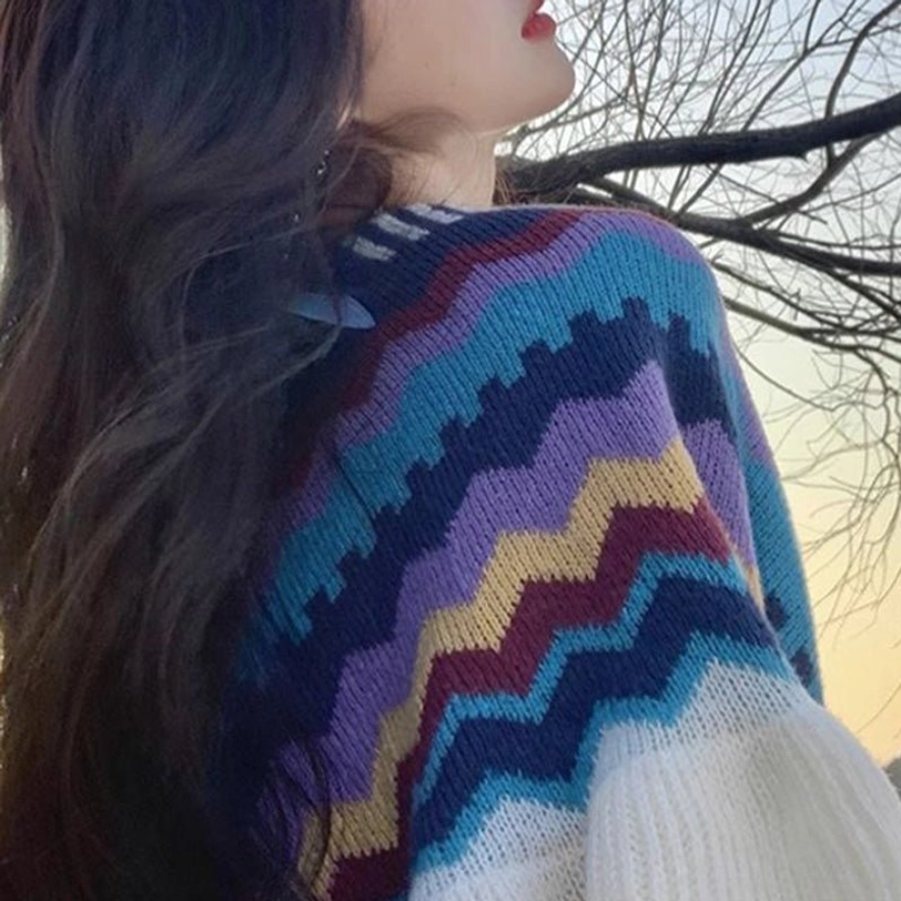 Tibetan shawl fabric close-up texture showing soft knitted material with colorful zigzag stripes and vibrant pattern detail