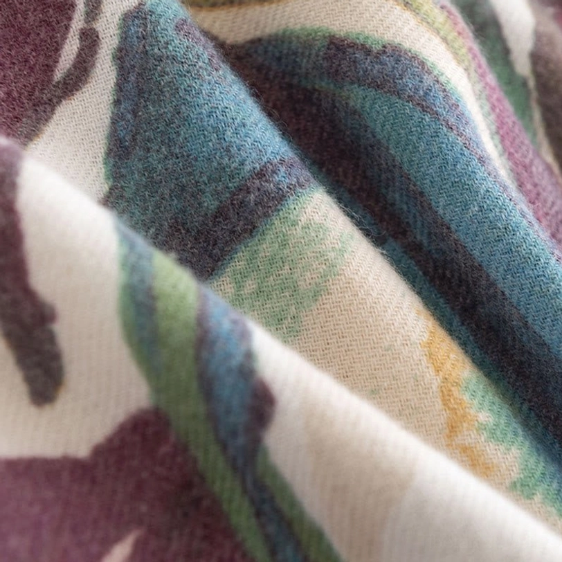 Styled Tibetan floral wrap in home setting demonstrating versatile wear options and elegant aesthetic