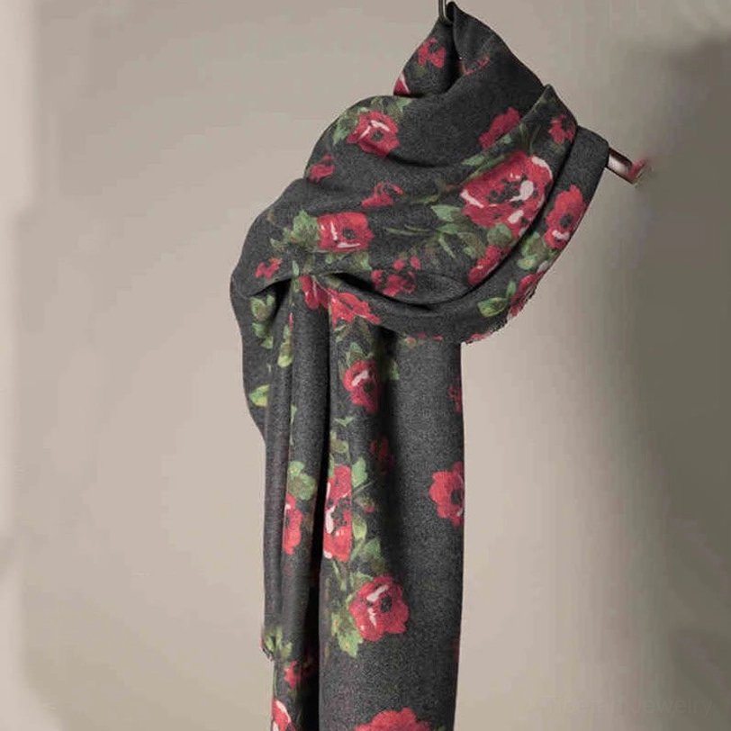 Tibetan rose floral shawl hung on metal hook showing wrinkled natural texture and detailed print quality