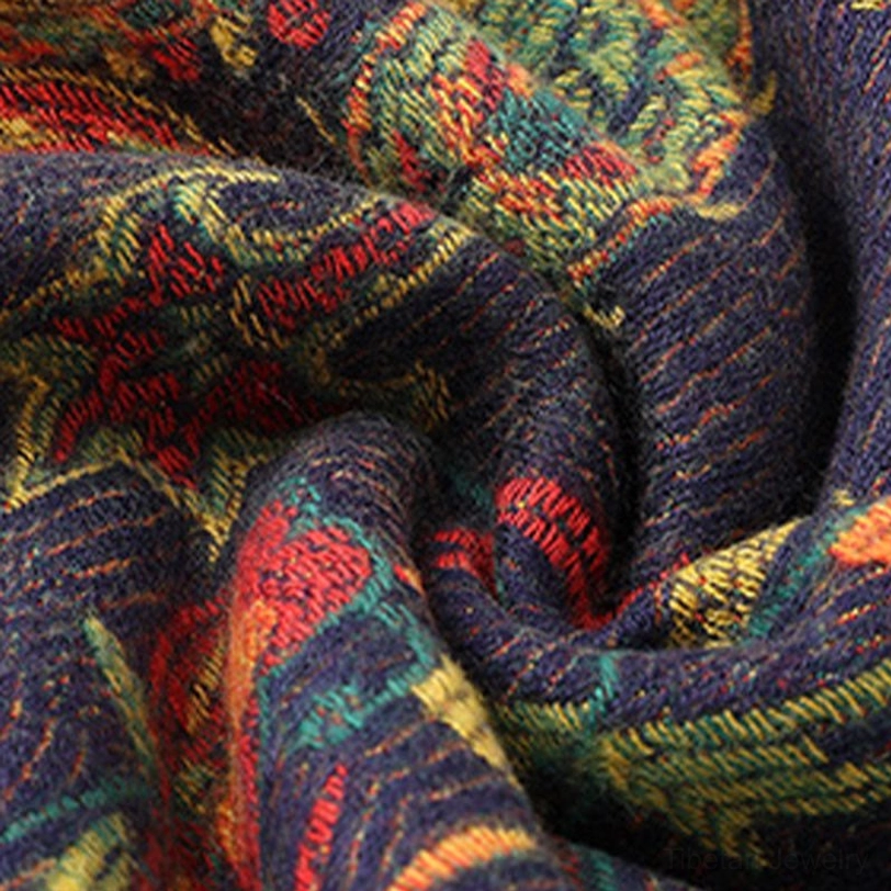 Shawl fabric close-up showing thick jacquard woven texture, intricate paisley floral pattern, earthy mixed tones on dark base