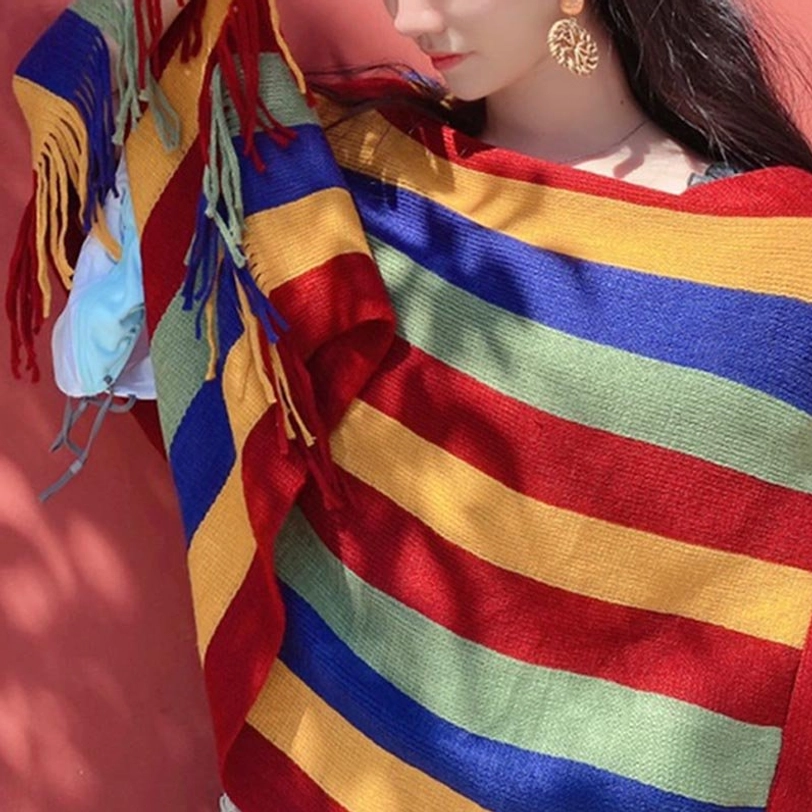 Tibetan striped shawl close-up detail shot showing knit texture stripes and decorative tassel fringe