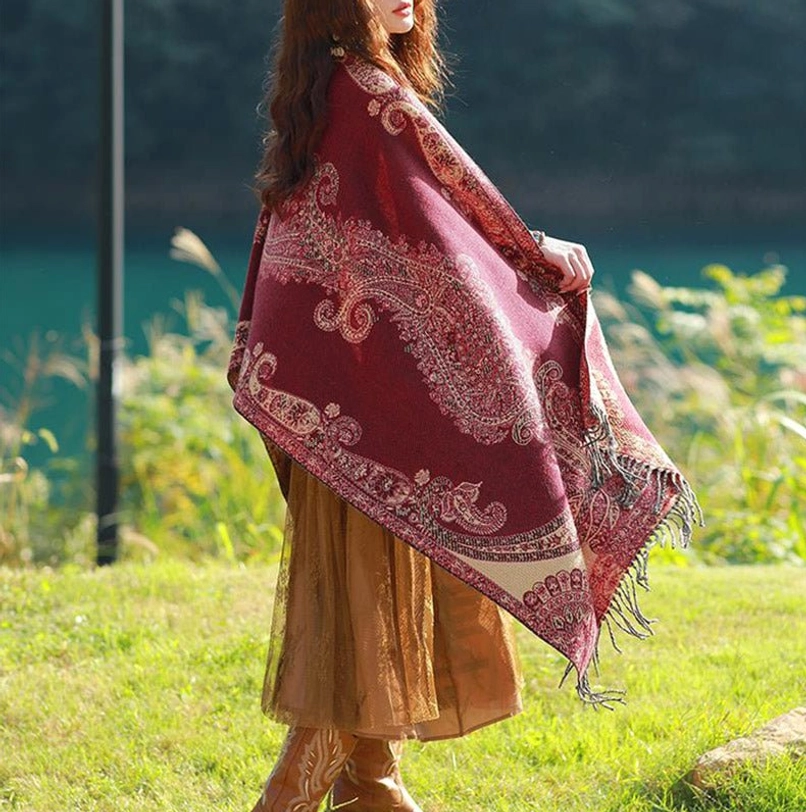 Tibetan paisley travel shawl draped loose fit showing woven vine motifs