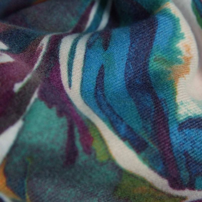 Macro shot of Tibetan scarf fabric revealing visible woven texture and vibrant watercolor printed colors
