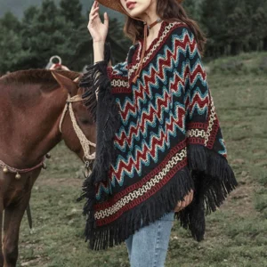 Blue red black striped Tibetan poncho side view with model in pasture near horse, demonstrating versatile styling with denim jeans
