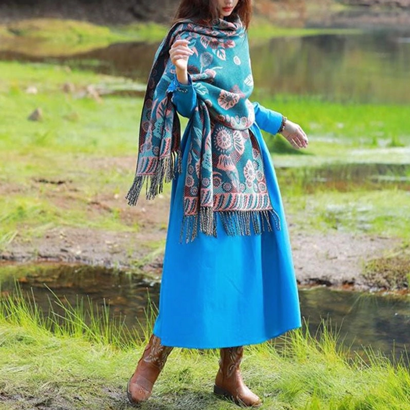 One-shoulder Tibetan floral wrap with fringe hem worn casually outdoors