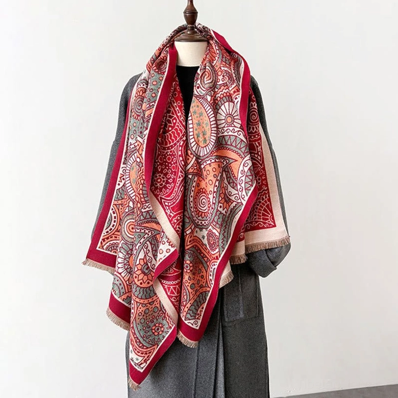 Tibetan ethnic shawl close-up detail showing intricate paisley pattern weave and traditional craftsmanship of geometric embellishments