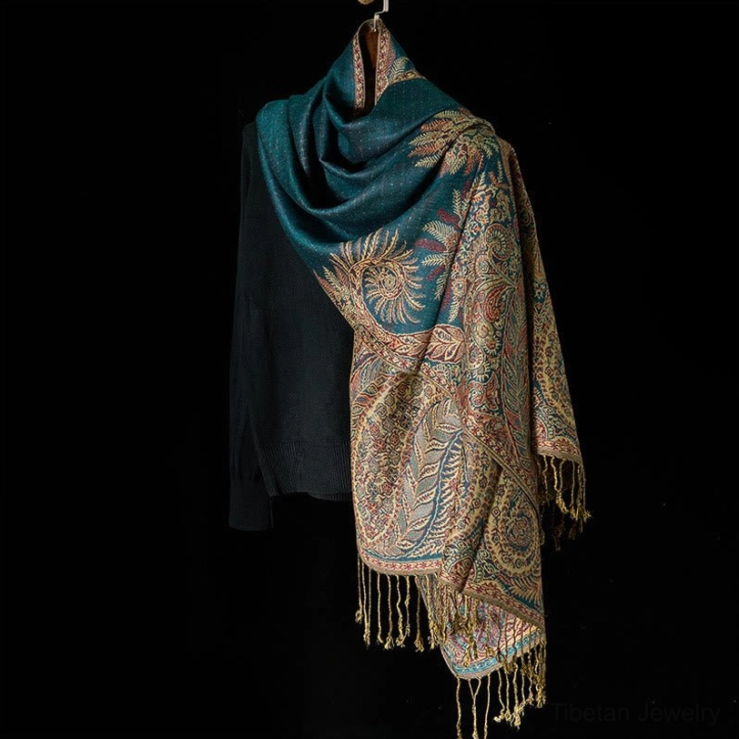 Tibetan floral tassel shawl side hanging view showing teal base with gold botanical jacquard weave
