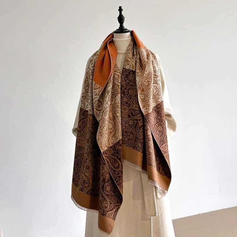 Tan-brown Tibetan handwoven shawl displaying solid block paisley design on mannequin in minimalist studio setting