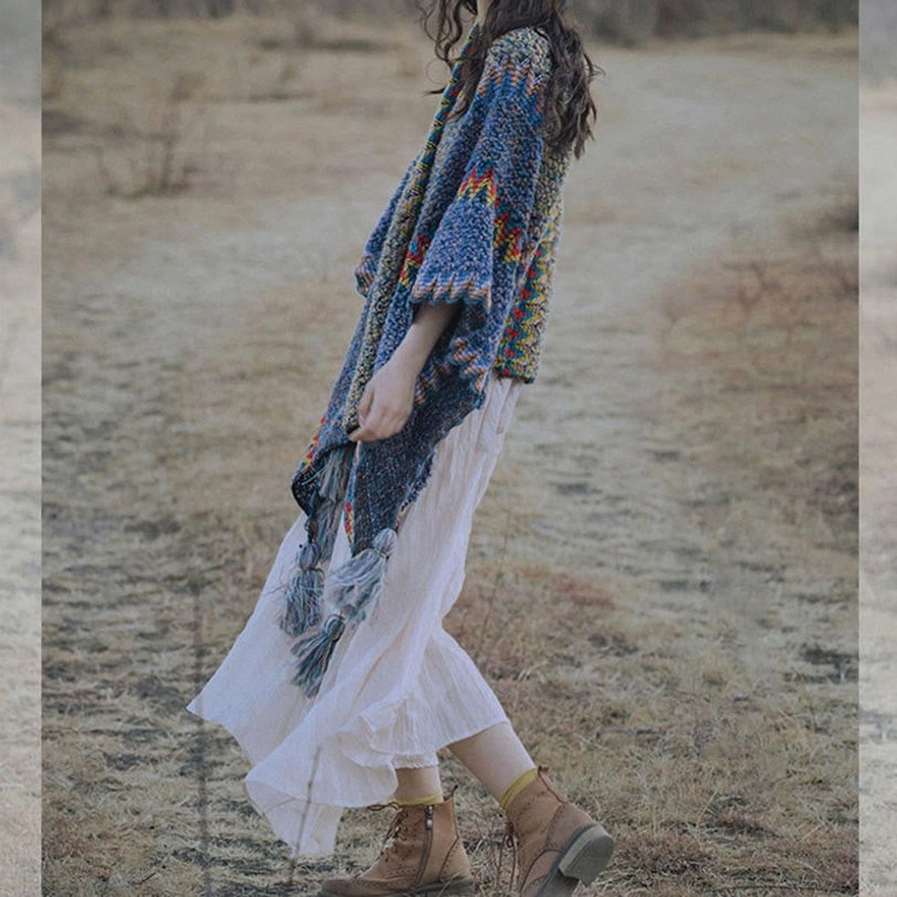 Detail view of Tibetan shawl decorative tassels and geometric ethnic pattern border design